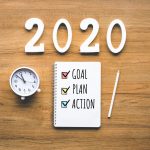 a-pad-with-check-marks-for-goal-plan-action-next-to-a-clock-and-2020